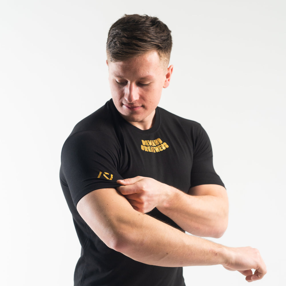 
                      
                        DG23 Gold Standard is our new meet shirt design highlighting Demand Greatness with a double outline font to showcase your impact on the platform. The DG23 Meet Shirt is IPF Approved. Shop the full A7 Powerlifting IPF Approved Equipment collection. The IPF Approved Kit includes Powerlifting Singlet, A7 Meet Shirt, A7 Zebra Wrist Wraps, A7 Deadlift Socks, Hourglass Knee Sleeves (Stiff Knee Sleeves and Rigor Mortis Knee Sleeves). All A7 Powerlifting Equipment shipping to UK, Norway, Switzerland and Iceland. 
                      
                    