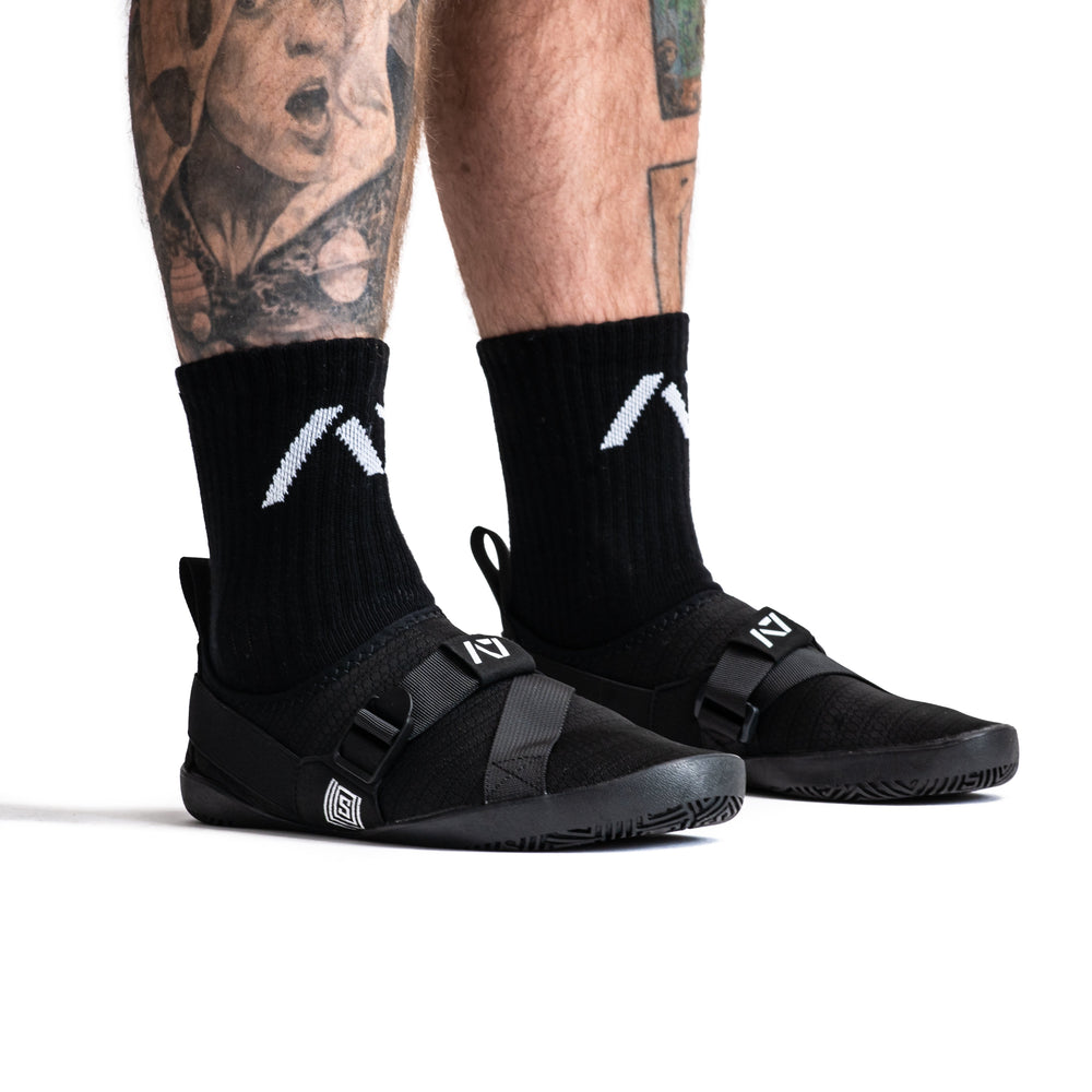 
                      
                        Simply designed with you in mind. With a 5 mm thin rubber grip sole, single pull diagonal/ Centre tension strap, all plastic components to allow easy washing, and even a convenient storage bag. These Soul Sumo v2 slippers are sure to impress. These slippers are ultra-compact and when rolled up are about the size of your wrist wraps. Our Soul Sumo Slippers are approved for IPF competitions and make a great addition to any IPF approved kit! A7 UK shipping to UK and Europe.
                      
                    