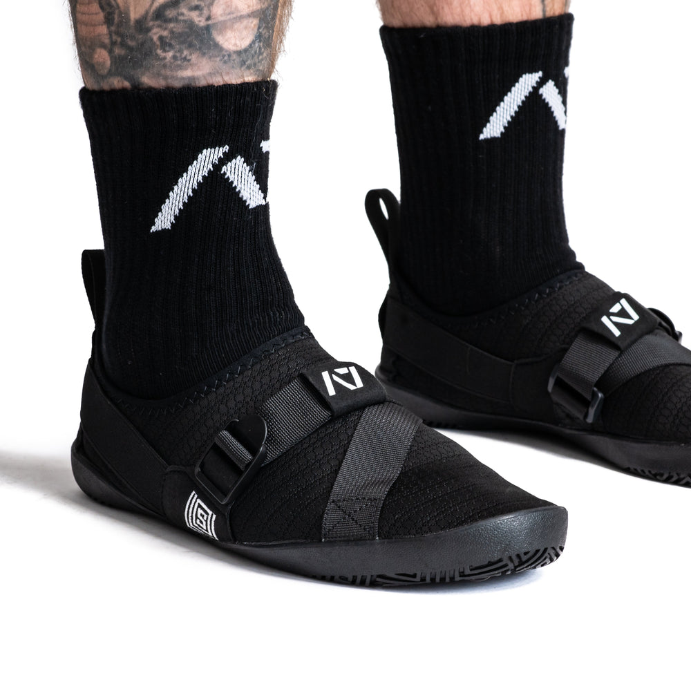 
                      
                        Simply designed with you in mind. With a 5 mm thin rubber grip sole, single pull diagonal/ Centre tension strap, all plastic components to allow easy washing, and even a convenient storage bag. These Soul Sumo v2 slippers are sure to impress. These slippers are ultra-compact and when rolled up are about the size of your wrist wraps. Our Soul Sumo Slippers are approved for IPF competitions and make a great addition to any IPF approved kit! A7 UK shipping to UK and Europe.
                      
                    