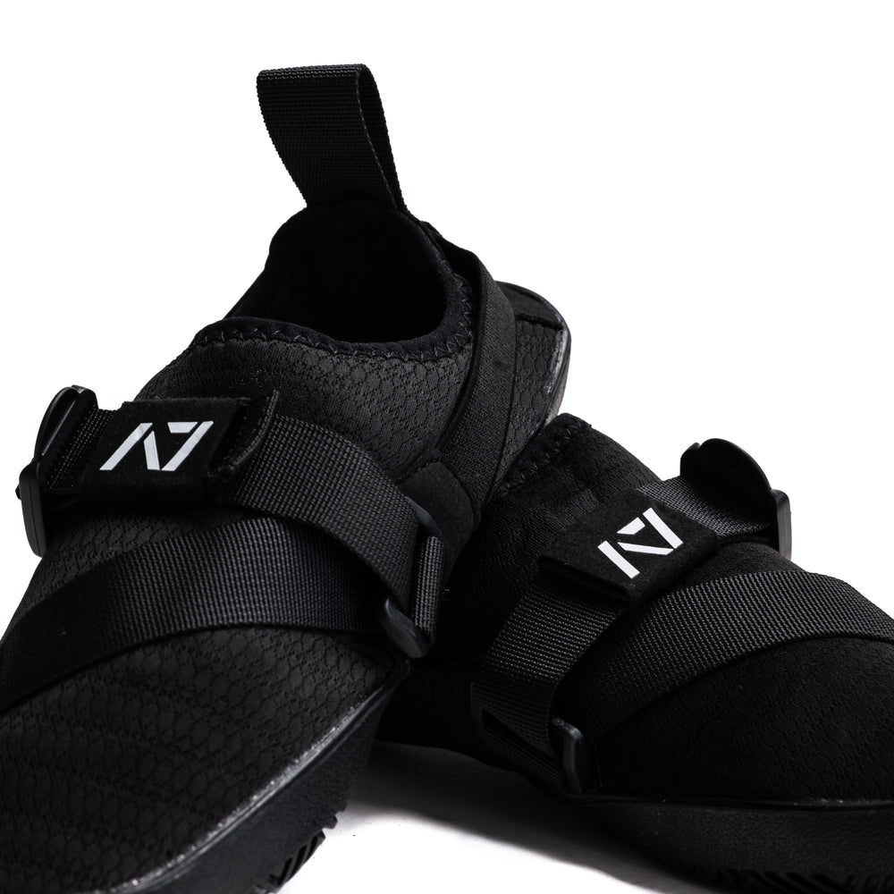 
                      
                        Simply designed with you in mind. With a 5 mm thin rubber grip sole, single pull diagonal/ Centre tension strap, all plastic components to allow easy washing, and even a convenient storage bag. These Soul Sumo v2 slippers are sure to impress. These slippers are ultra-compact and when rolled up are about the size of your wrist wraps. Our Soul Sumo Slippers are approved for IPF competitions and make a great addition to any IPF approved kit! A7 UK shipping to UK and Europe.
                      
                    